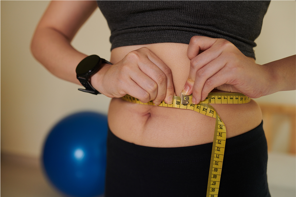woman measuring her waist | gastrointestinal surgeon in Sydney